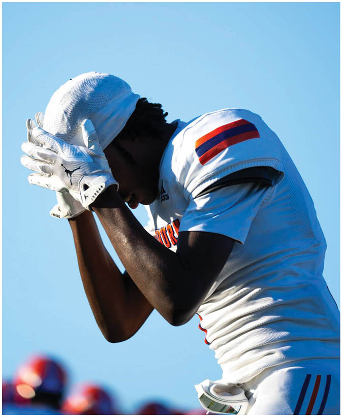 A group of football players wearing black and white uniforms. Description generated by AI