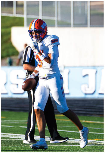 A football player running on the field. Description generated by AI
