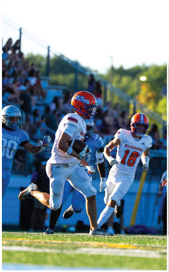 A football player running on the field. Description generated by AI