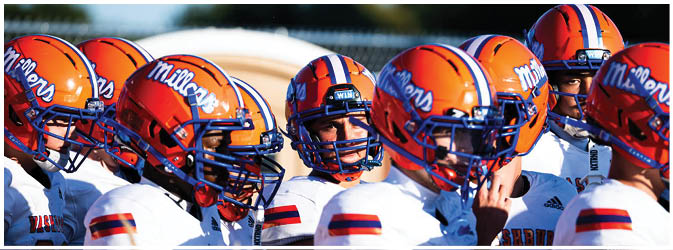A group of football players on a field. Description generated by AI