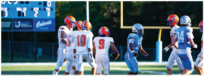 A group of football players on a field. Description generated by AI