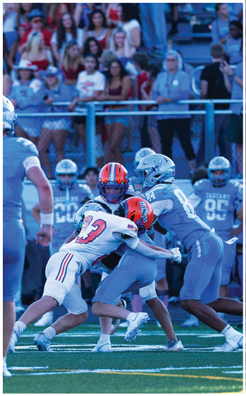A football player running on the field. Description generated by AI