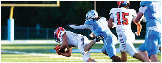 A football player is sliding on the ground. Description generated by AI