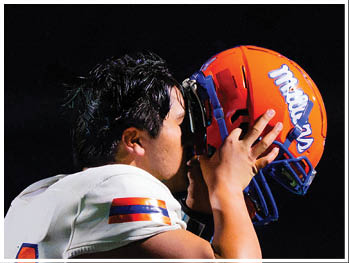 A football player running on the field. Description generated by AI