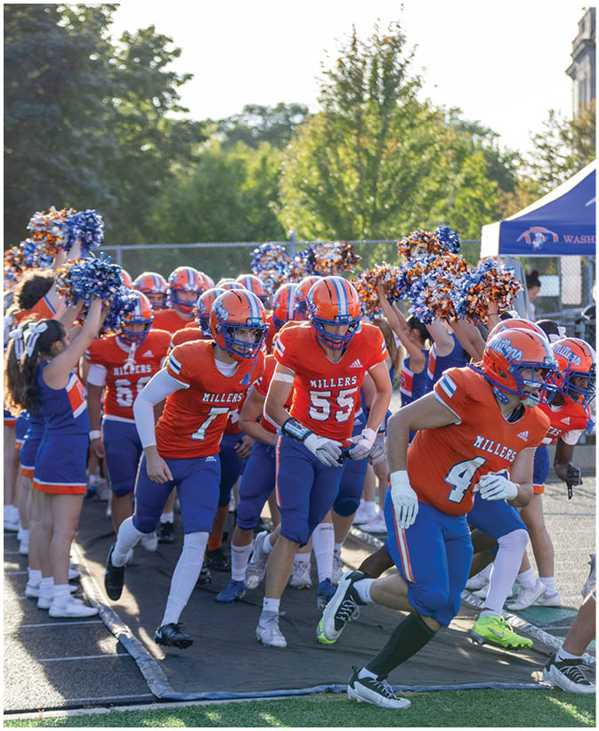 A group of football players wearing black and white uniforms. Description generated by AI