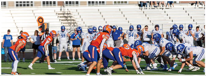 A group of football players on a field. Description generated by AI