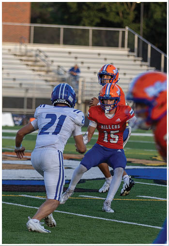 A football player running on the field. Description generated by AI