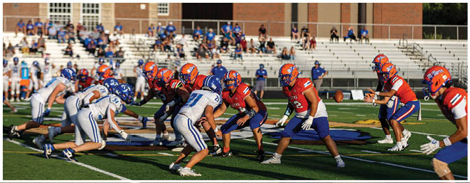 A football player is sliding on the ground. Description generated by AI