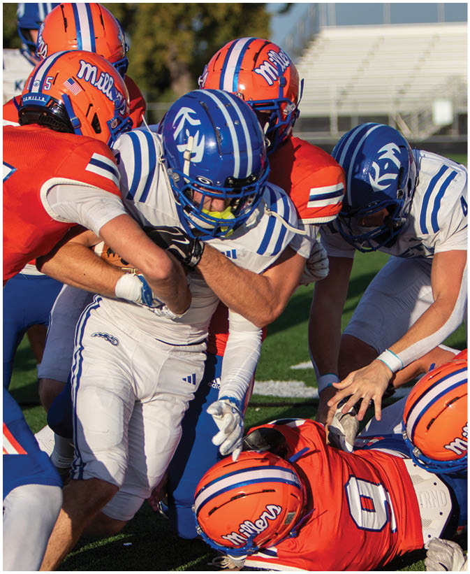 A group of football players wearing black and white uniforms. Description generated by AI