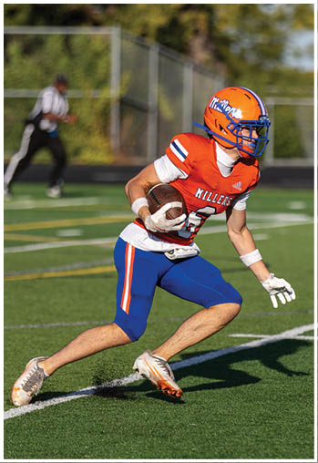 A football player running on the field. Description generated by AI