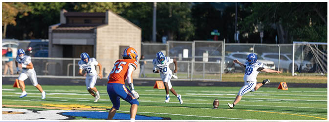 A group of football players on a field. Description generated by AI