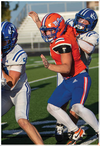 A football player running on the field. Description generated by AI