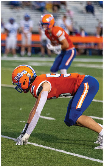A football player running on the field. Description generated by AI