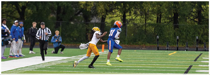 A group of football players on a field. Description generated by AI