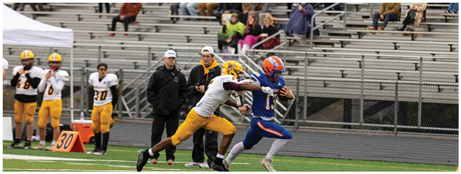 A football player is sliding on the ground. Description generated by AI