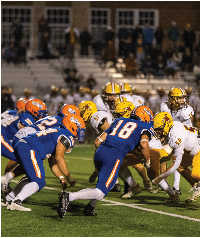 A group of football players wearing black and white uniforms. Description generated by AI