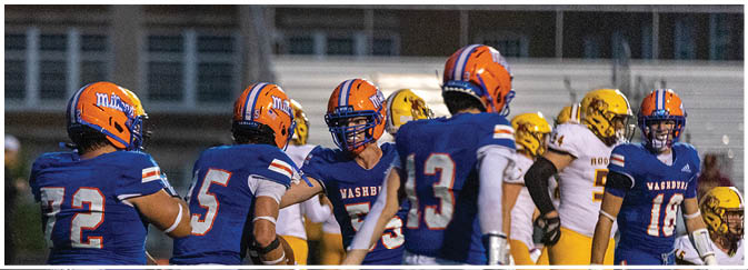 A group of football players on a field. Description generated by AI