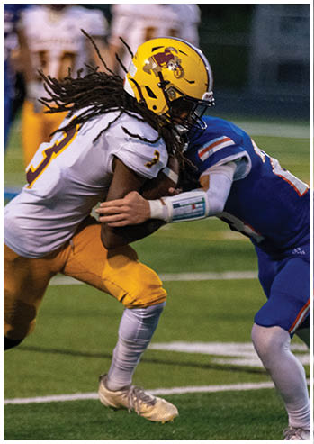 A football player running on the field. Description generated by AI