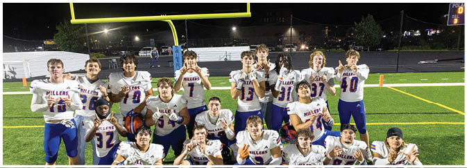 A group of football players on a field. Description generated by AI