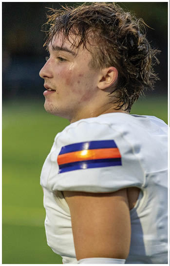 A football player running on the field. Description generated by AI