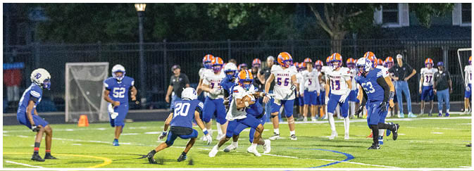 A group of football players on a field. Description generated by AI