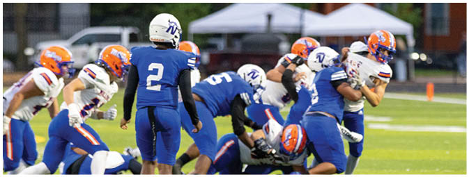 A football player is sliding on the ground. Description generated by AI