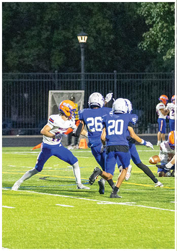 A football player running on the field. Description generated by AI