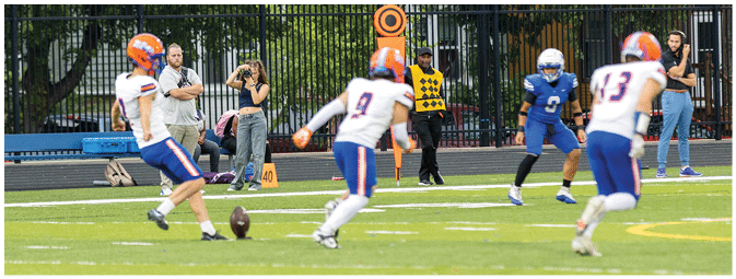A football player is sliding on the ground. Description generated by AI