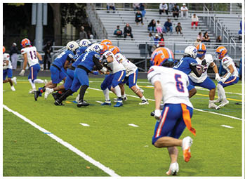 A football player running on the field. Description generated by AI
