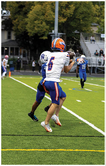 A football player running on the field. Description generated by AI