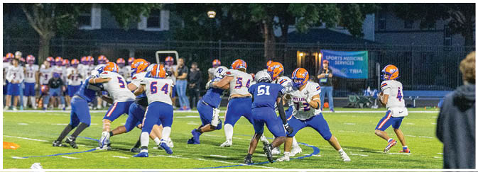 A group of football players on a field. Description generated by AI