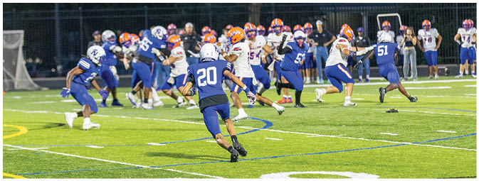 A football player is sliding on the ground. Description generated by AI