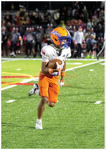 A football player running on the field. Description generated by AI