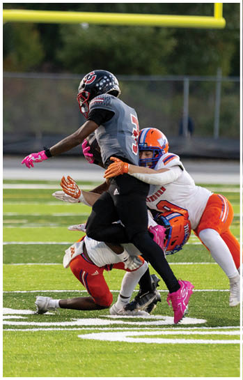 A football player running on the field. Description generated by AI