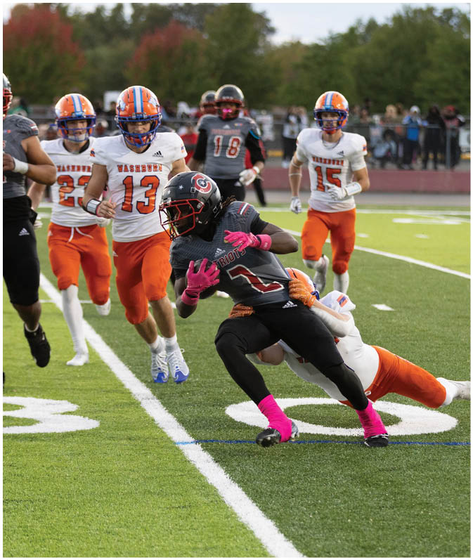 A group of football players wearing black and white uniforms. Description generated by AI