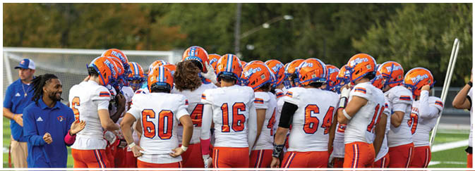A group of football players on a field. Description generated by AI