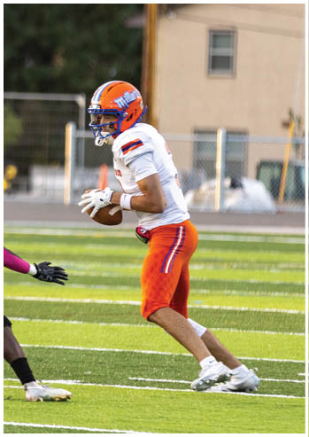 A football player running on the field. Description generated by AI
