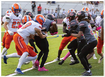 A football player running on the field. Description generated by AI
