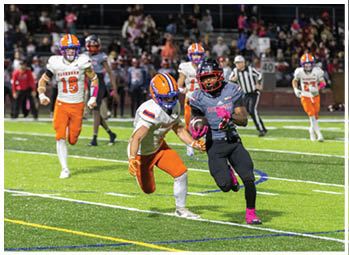A football player running on the field. Description generated by AI