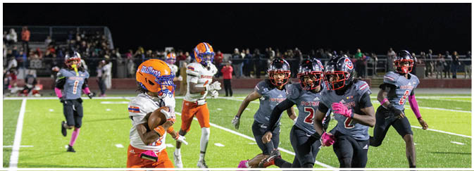 A group of football players on a field. Description generated by AI