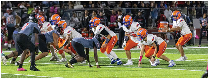A football player is sliding on the ground. Description generated by AI