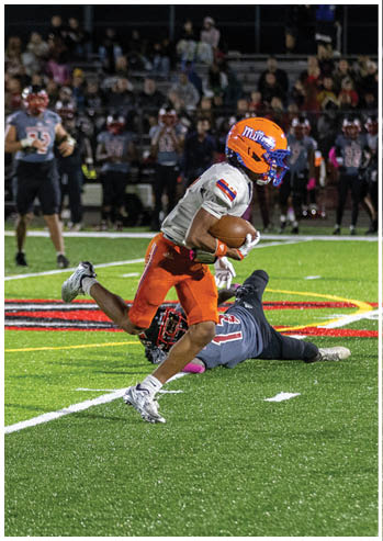 A football player running on the field. Description generated by AI