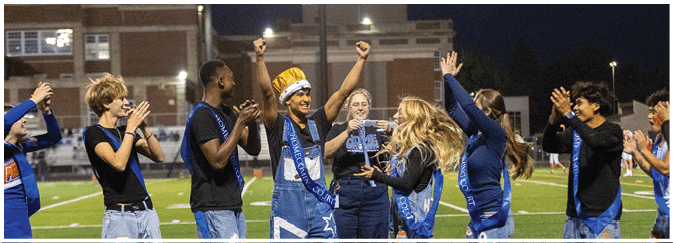 A group of football players on a field. Description generated by AI