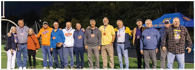 A group of football players on a field. Description generated by AI