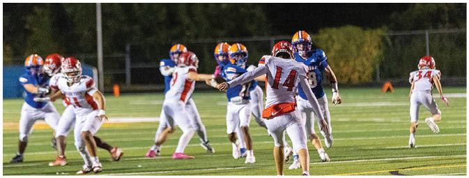 A football player is sliding on the ground. Description generated by AI