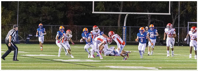 A group of football players on a field. Description generated by AI