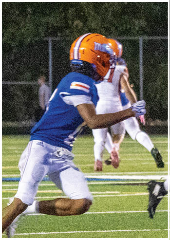A football player running on the field. Description generated by AI