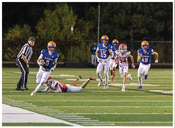 A football player running on the field. Description generated by AI