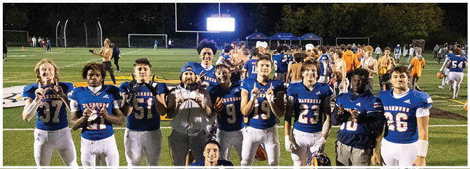 A group of football players on a field. Description generated by AI