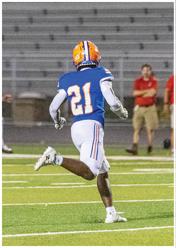 A football player running on the field. Description generated by AI